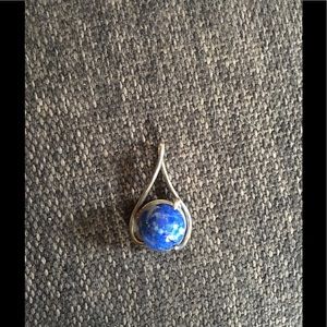 Silver charm with precious stone